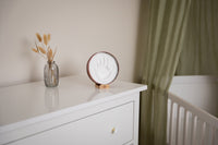 With its warm terracotta tones, rainbow accents, and elegant wooden stand, this baby keepsake is perfect for celebrating your little one’s milestones while enhancing your nursery decor.