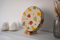 With its elegant round design and natural wooden stand, this personalized baby memory box is perfect for celebrating the arrival of your little one.