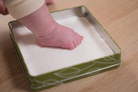 A modern baby footprint frame with a timeless olive tree theme.