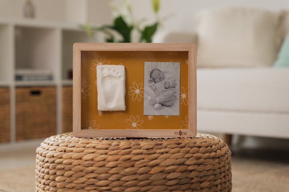Classic Frame Daisy Ochre allows you to showcase a cherished photo alongside your baby’s hand or footprint.