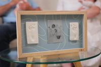 Display two adorable baby hand or footprints alongside a favorite photo with  2 Prints Frame Blue Abstract
